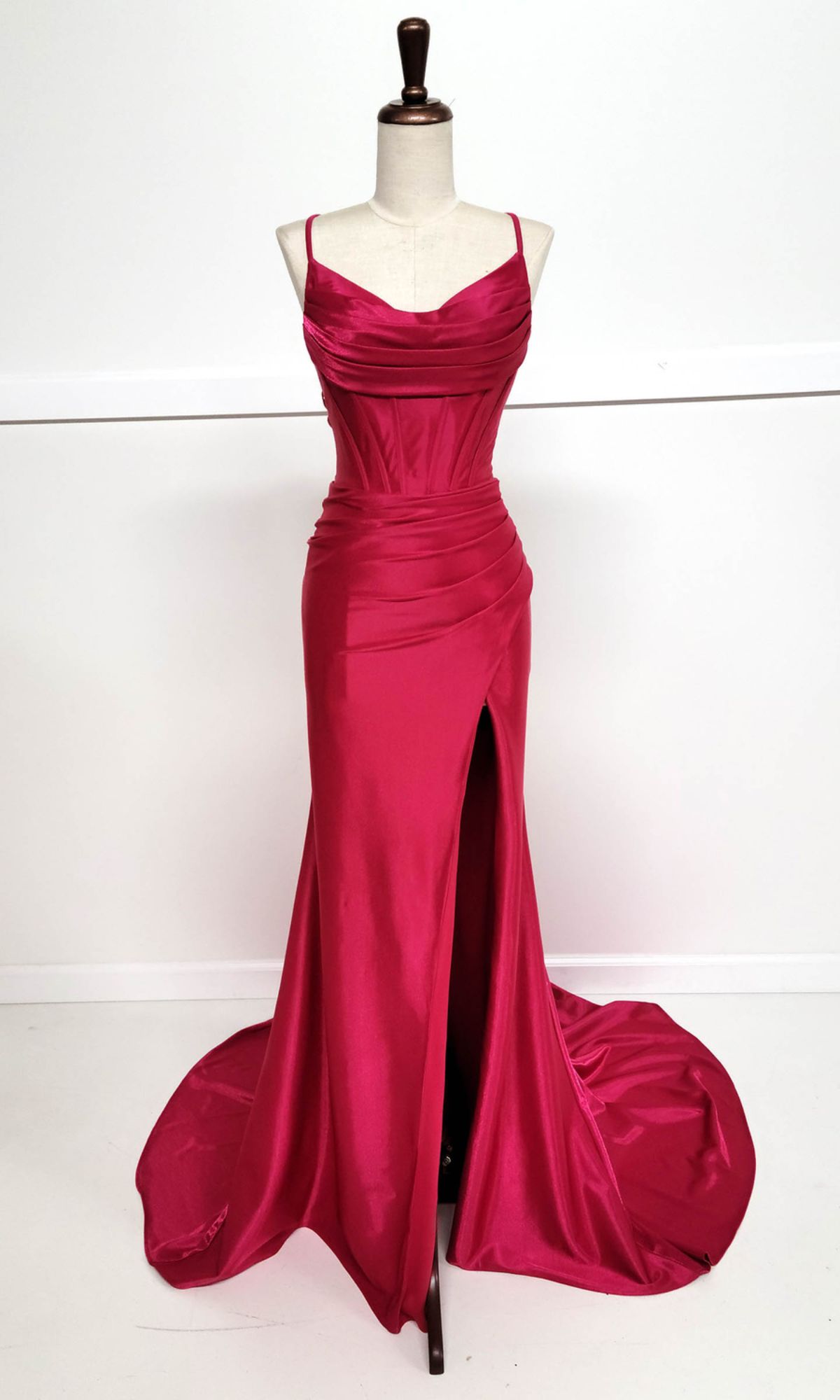 The Cowl-Neck Long Prom Dress: Chicas C326, a deep pink satin gown with spaghetti straps, ruched bodice, high front slit, and slight train, is displayed on a dress form against a white background.